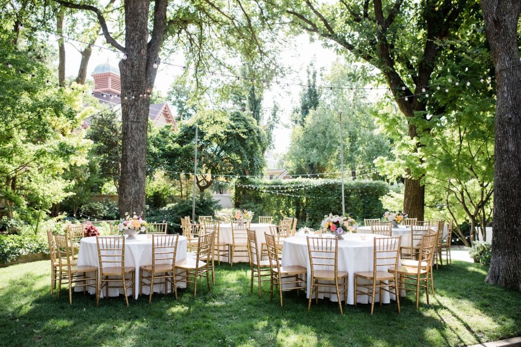 Round Tables and Bistro String Lights nestled among trees