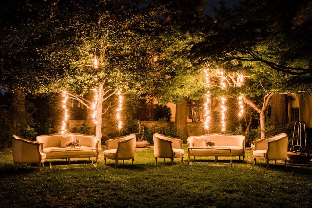 Backyard Wedding Inspo: An evening shot of the lounge seating area with string lights behind